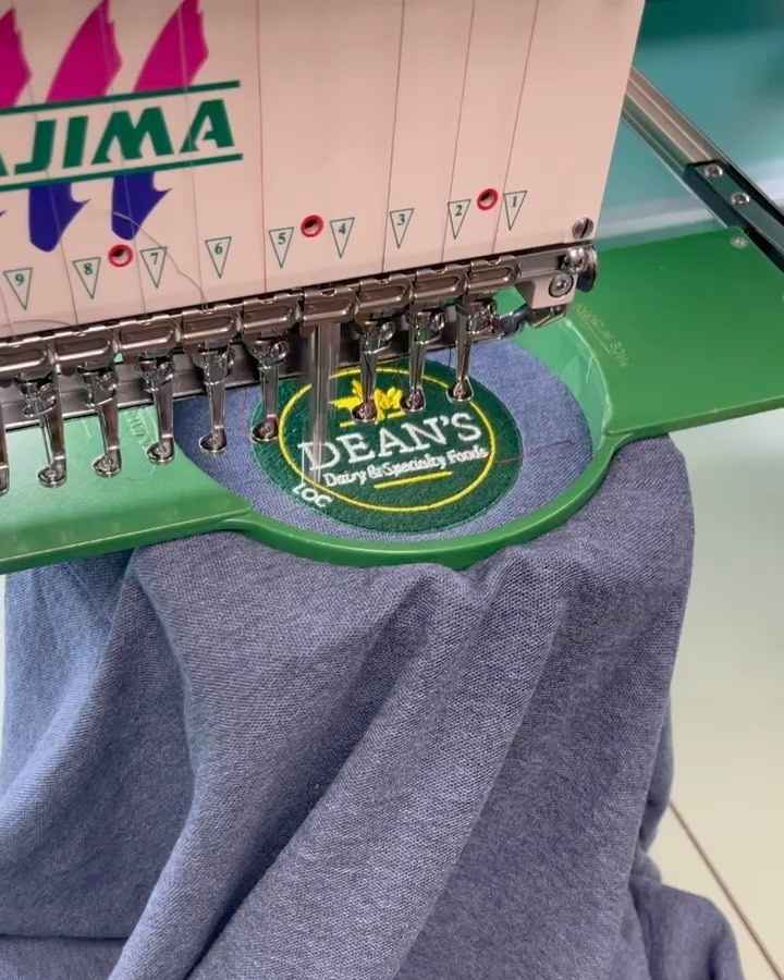Dean's Specialty Foods Embroiderry Dean's Specialty Foods Embroiderry on a shirt by Zone West